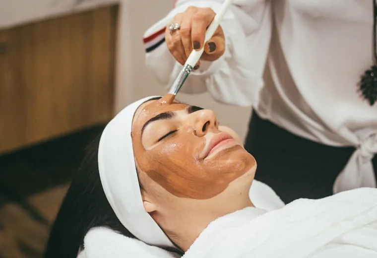 Client receiving a facial treatment in a med spa treatment room