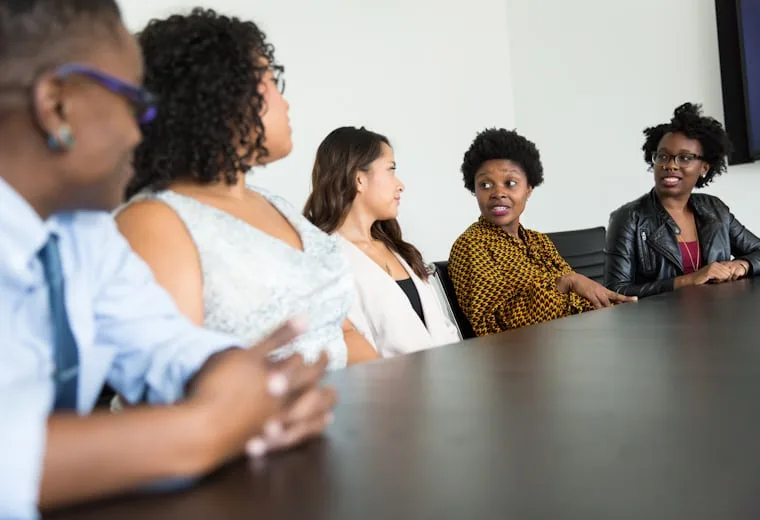 Agency team talking through client work around a conference table